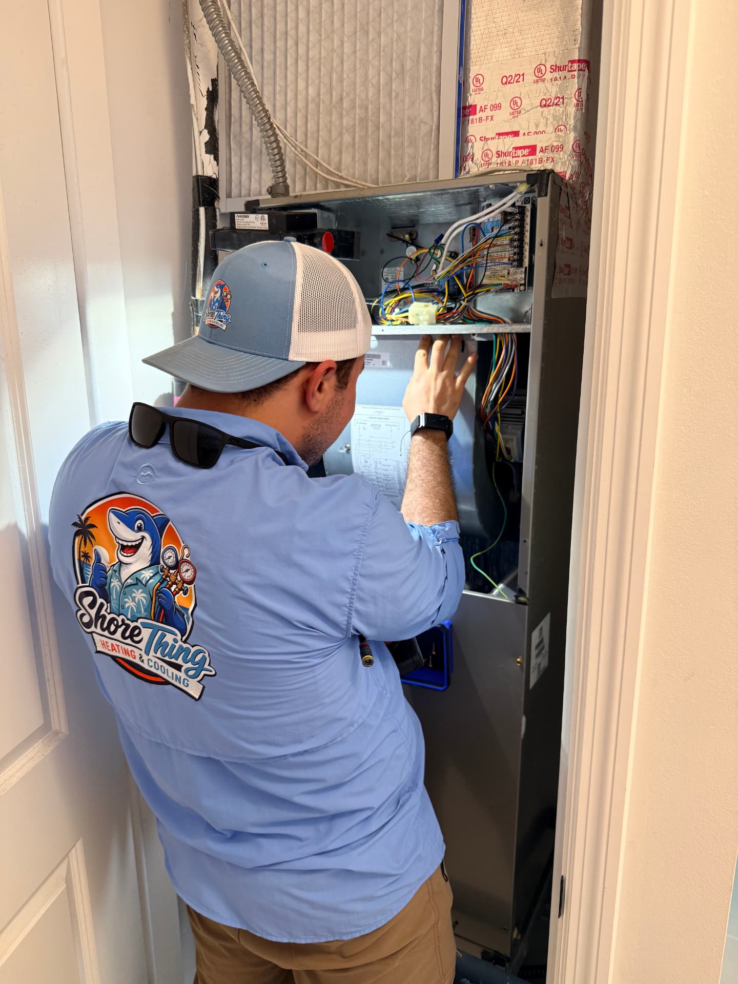 A Shore Thing Heating & Cooling technician servicing an air handler in Port St. Lucie